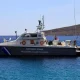 Barcă cu motor și navă a Pazei de Coastă în timpul operațiunii de salvare lângă insula Chios